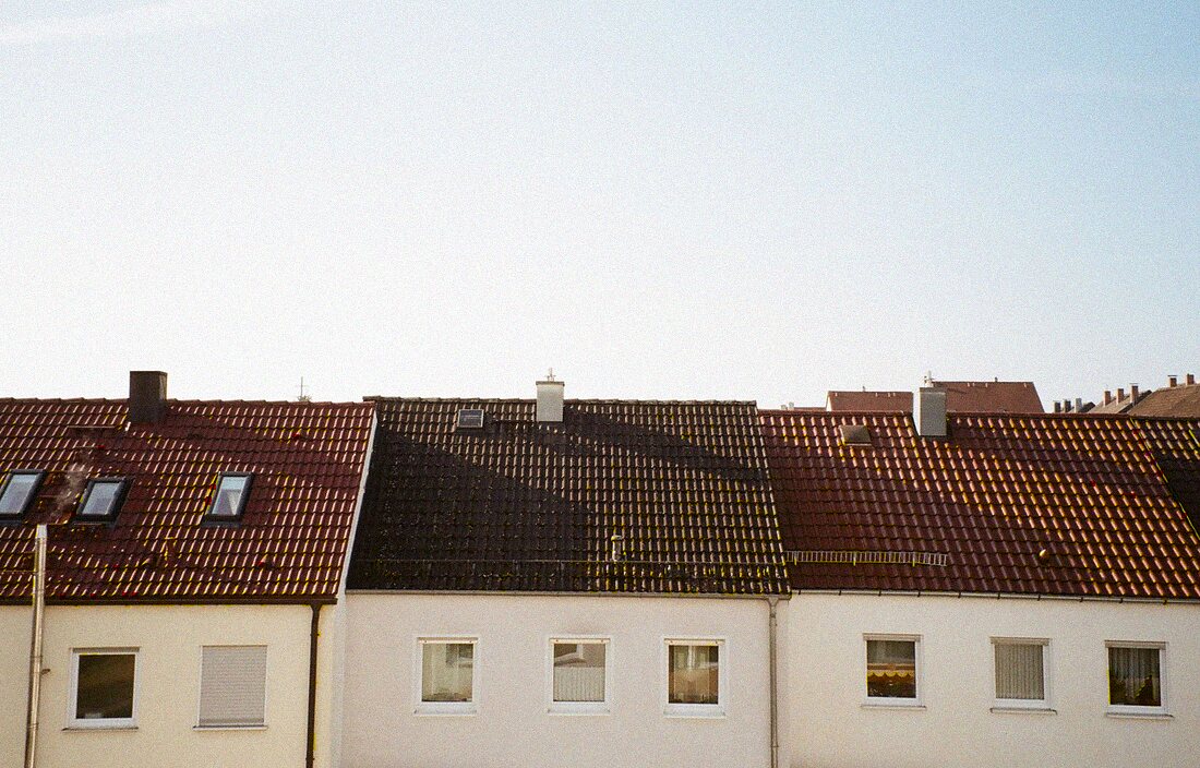 Rows of barrel tile rooftops under a clear sky